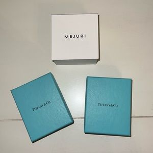 Two Tiffany boxes and one Mejuri box